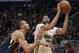 New Orleans Pelicans forward Anthony Davis (23) shoots against Utah Jazz center Rudy Gobert (27) in the first half of an NBA basketball game in New Orleans, Sunday, March 11, 2018. (AP Photo/Scott Threlkeld)