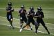 Baltimore Ravens quarterbacks Joe Flacco, left, runs a drill alongside fellow quarterbacks Josh Woodrum, second from left, Lamar Jackson and Robert Griffin III during an NFL football organized team activity at the team's headquarters in Owings Mills, Md., Thursday, May 24, 2018. (AP Photo/Patrick Semansky)