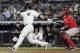 Los Angeles Angels catcher Martin Maldonado watches as New York Yankees' Gleyber Torres, left, follows through on a home run during the seventh inning of a baseball game Friday, May 25, 2018, in New York. (AP Photo/Frank Franklin II)