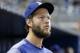 Los Angeles Dodgers' Clayton Kershaw looks out of the dugout during the eighth inning of a baseball game against the Miami Marlins, Thursday, May 17, 2018, in Miami. Kershaw (left biceps tendinitis) took another step in his recovery progressing by playing catch from 120 feet for the first time. He's not expected to throw from a mound until next week. The Dodgers defeated the Marlins 7-0. (AP Photo/Wilfredo Lee)