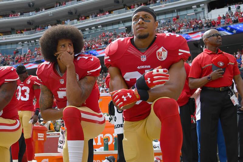 SANTA CLARA, CA - OCTOBER 02: (L-R) Eli Harold #58, Colin Kaepernick #7 and Eric Reid #35 of the San Francisco 49ers kneel on the sideline during the National Anthem prior to the game against the Dallas Cowboys at Levi's Stadium on October 2, 2016 in Santa Clara, California. (Photo by Thearon W. Henderson/Getty Images)