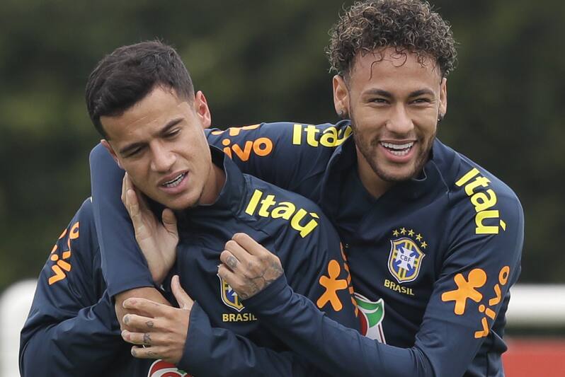 Brazil's Neymar, right, hugs Philippe Coutinho, left, during a soccer team training session in London, Tuesday, May 29, 2018. Brazil will play Croatia in a pre-world cup friendly at Anfield Stadium in Liverpool, England on Sunday. (AP Photo/Kirsty Wigglesworth)