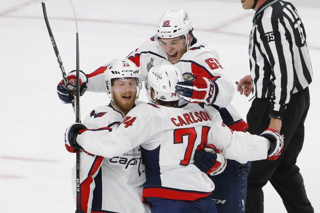 Washington Capitals center Lars Eller, left, celebrates his goal with defenseman John Carlson, center, and left wing Andre Burakovsky, of Austria, during the first period in Game 2 of the NHL hockey Stanley Cup Finals against the Vegas Golden Knights on Wednesday, May 30, 2018, in Las Vegas. (AP Photo/Ross D. Franklin)