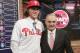 Baseball commissioner Rob Manfred, right, poses for photos with Alec Bohm, a third baseman from Wichita State University in Omaha, Neb., reacts after being selected No. 3 by the Philadelphia Phillies during the first round of the Major League Baseball draft Monday, June 4, 2018, in Secaucus, N.J. (AP Photo/Frank Franklin II)