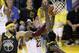 Cleveland Cavaliers forward LeBron James (23) shoots between Golden State Warriors center JaVale McGee (1) and forward Draymond Green during the second half of Game 2 of basketball's NBA Finals in Oakland, Calif., Sunday, June 3, 2018. (AP Photo/Marcio Jose Sanchez)