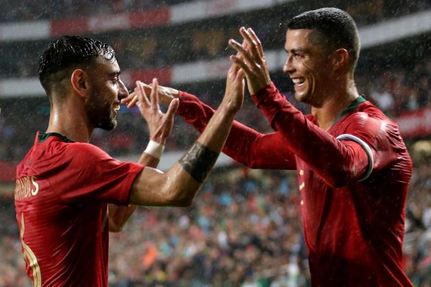 Portuguese defender Bruno Fernandes (L) celebrates with captain Cristiano Ronaldo after scoring a goal during the friendly football match between Portugal and Algeria, on June 7, 2018 at the Luz stadium  in Lisbon. (Photo by JOSE MANUEL RIBEIRO / AFP)        (Photo credit should read JOSE MANUEL RIBEIRO/AFP/Getty Images)