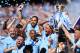 MANCHESTER, ENGLAND - MAY 06: Vincent Kompany of Manchester City lifts the Premier League Trophy alongside David Silva, Nicolas Otamendi and Fernandinho as Manchester City celebrate winning the Premier League Title during the Premier League match between Manchester City and Huddersfield Town at Etihad Stadium on May 6, 2018 in Manchester, England. (Photo by Laurence Griffiths/Getty Images)