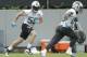Carolina Panthers' Luke Kuechly, left, runs a drill during practice at the NFL football team's facility in Charlotte, N.C., Tuesday, May 29, 2018. (AP Photo/Chuck Burton)