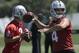 Oakland Raiders quarterbacks Derek Carr (4) and Christian Hackenberg (7) throw passes during practice at the team's NFL football training facility in Alameda, Calif., Tuesday, May 29, 2018. (AP Photo/Jeff Chiu)