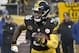 Pittsburgh Steelers running back Le'Veon Bell (26) runs the ball against the New England Patriots during the first half of an NFL football game in Pittsburgh, Sunday, Dec. 17, 2017. (AP Photo/Don Wright)