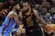 Cleveland Cavaliers' LeBron James, right, drives past Oklahoma City Thunder's Paul George in the second half of an NBA basketball game, Saturday, Jan. 20, 2018, in Cleveland. (AP Photo/Tony Dejak)
