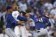 Texas Rangers starting pitcher Cole Hamels, left, restrains Los Angeles Dodgers' Matt Kemp as Kemp scuffles with Rangers catcher Robinson Chirinos during the third inning of a baseball game Wednesday, June 13, 2018, in Los Angeles. (AP Photo/Jae C. Hong)