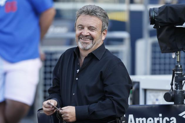 Los Angeles Dodgers general manager Ned Colletti finds something to laugh about while watching his team during warmups prior to a baseball game against the San Diego Padres Friday, June 20, 2014, in San Diego. (AP Photo/Lenny Ignelzi)