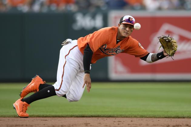 Baltimore Orioles shortstop Manny Machado (13) fields a ball that went for a single by Miami Marlins' JT Riddle during the ninth inning of a baseball game, Saturday, June 16, 2018, in Baltimore. (AP Photo/Nick Wass)