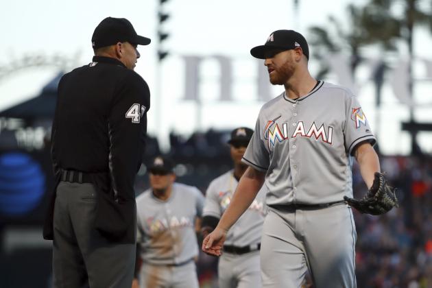 Miami Marlins pitcher Dan Straily, right, speaks with home plate umpire Andy Fletcher after Straily hit San Francisco Giants' Buster Posey with a pitch and was ejected by Fletcher during the second inning of a baseball game Tuesday, June 19, 2018, in San Francisco. (AP Photo/Ben Margot)