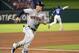 Houston Astros' Alex Bregman rounds third base on his way to scoring on a single by Jose Altuve off Texas Rangers starting pitcher Cole Hamels during the fourth inning of a baseball game Thursday, June 7, 2018, in Arlington, Texas. Houston won 5-2. (AP Photo/Jeffrey McWhorter)