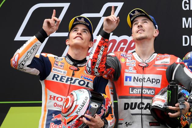 Ducati Team's Spanish rider Jorge Lorenzo (R),first placed and Repsol Honda Team's Spanish rider Marc Marquez (L), second placed, look up in memory of late Spanish rider Andreas Perez, on the podium of the Catalunya MotoGP Grand Prix race at the Catalunya racetrack in Montmelo, near Barcelona on June 17, 2018. (Photo by LLUIS GENE / AFP)        (Photo credit should read LLUIS GENE/AFP/Getty Images)