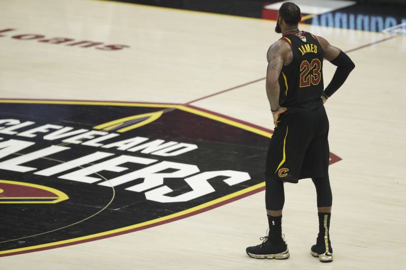 Cleveland Cavaliers' LeBron James watches in the first half of Game 4 of basketball's NBA Finals against the Golden State Warriors, Friday, June 8, 2018, in Cleveland. (AP Photo/Tony Dejak)
