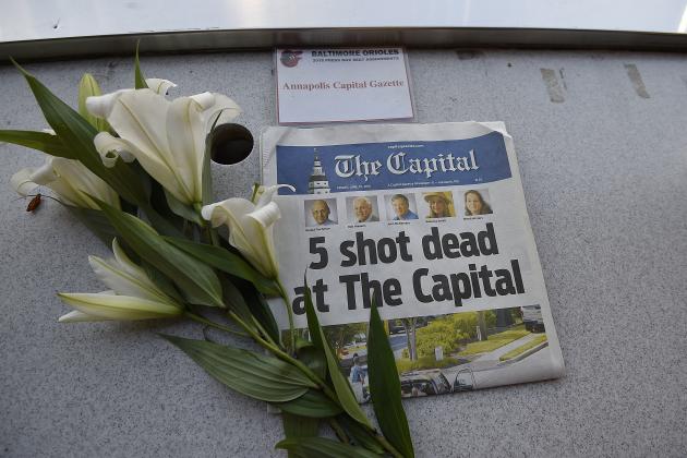A memorial for Capital Gazette sports writer John McNamara is displayed at a seat in the press box before a baseball game between the Baltimore Orioles and the Los Angeles Angels, Friday, June 29, 2018, in Baltimore. McNamara is one of five victims in a  shooting in the newspaper's newsroom Thursday in Annapolis, Md. (AP Photo/Gail Burton)
