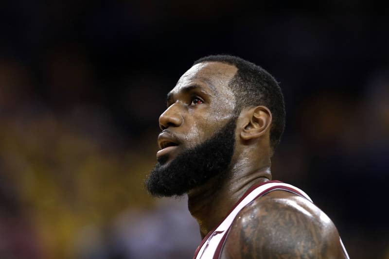 FILE - In this June 3, 2018, file photo, Cleveland Cavaliers forward LeBron James watches during the first half of Game 2 of basketball's NBA Finals between the Golden State Warriors and the Cleveland Cavaliers in Oakland, Calif. Two people familiar with the decision say James has told the Cavaliers he is declining his $35.6 million contract option for next season and is a free agent. James' representatives told the Cavs on Friday, June 29, 2018, said the people who spoke to the Associated Press on condition of anonymity because the team is not publicly commenting on moves ahead of free agency opening Sunday. (AP Photo/Marcio Jose Sanchez, File)