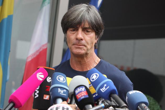 TOPSHOT - Germany's head coach Joachim Loew talks to media as he arrives at Frankfurt international airport on June 28, 2018, after flying back from Moscow following the German national football team's defeat in the Russia 2018 football World Cup. - Germany's embattled national team braced for a cold homecoming on June 28, 2018 after a shock World Cup exit that has plunged the football-mad nation into mourning and leaves the future of coach Joachim Loew in the balance. (Photo by Daniel ROLAND / AFP)        (Photo credit should read DANIEL ROLAND/AFP/Getty Images)