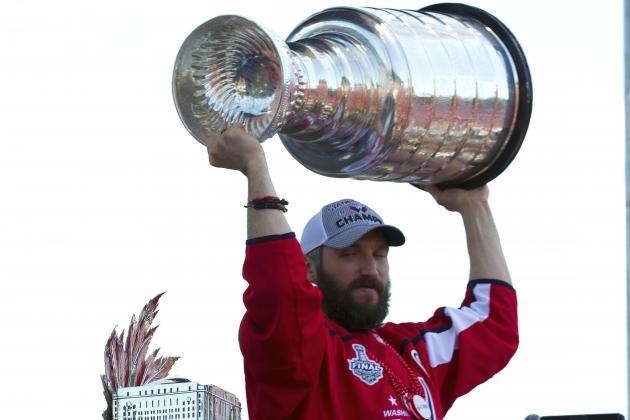 Washington Capitals NHL hockey team left wing Alex Ovechkin, from Russia, holds up the Stanley Cup during a victory parade and rally at The National Mall, Tuesday, June 12, 2018, in Washington. (AP Photo/Jose Luis Magana)