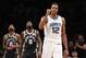 Charlotte Hornets center Dwight Howard (12) reacts during the second half of the team's NBA basketball game against the Brooklyn Nets on Wednesday, March 21, 2018, in New York. Brooklyn Nets guard Allen Crabbe (33) and forward Quincy Acy (13) watch a video replay. The Hornets won 111-105. (AP Photo/Kathy Willens)