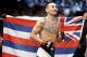 FILE - In this Dec. 12, 2015 file photo, Max Holloway warms up before fighting Jeremy Stephens in a featherweight mixed martial arts bout at UFC 194 in Las Vegas. The UFC takes another step toward filling Conor McGregor's sizable featherweight shoes when Max Holloway takes on Anthony Pettis in the main event of UFC 206 on Saturday night in Toronto. (AP Photo/John Locher, File)