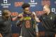   Cleveland Cavaliers draft pick, Collin Sexton, center, looks at his jersey with Cleveland Cavaliers general manager Koby Altman, left and coach Tyronn Cavaliers read at a press conference at Cavaliers training center in Independence, Ohio, Friday, June 22, 2018. Sexton was the eighth draft pick. (Photo AP / Long Phil) 
