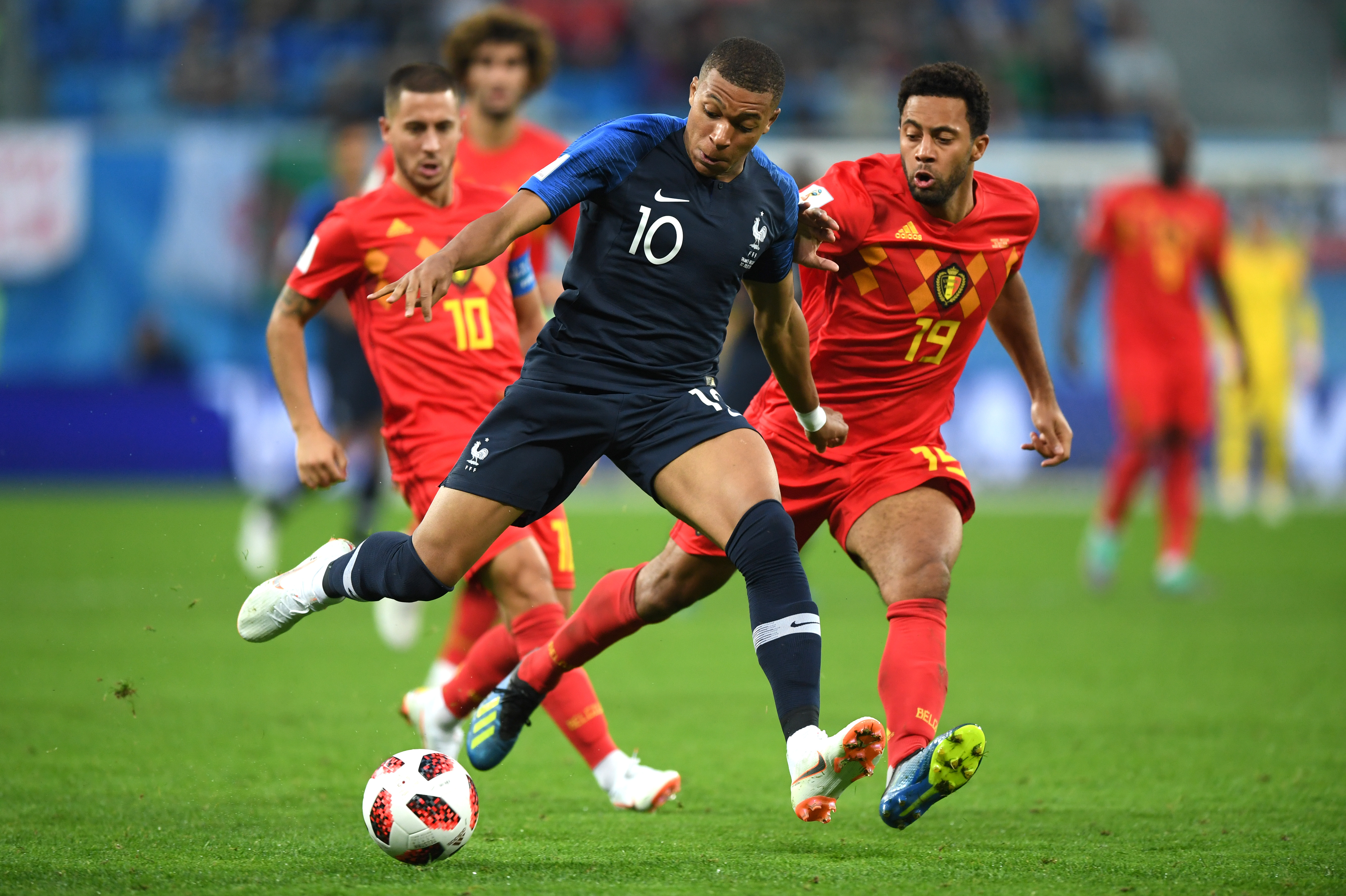 SAINT PETERSBURG, RUSSIA - JULY 10: Kylian Mbappe of France challenge for the ball with Moussa Dembele of Belgium during the 2018 FIFA World Cup Russia Semi Final match between Belgium and France at Saint Petersburg Stadium on July 10, 2018 in Saint Petersburg, Russia. (Photo by Shaun Botterill/Getty Images)