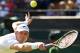 TOPSHOT - South Africa's Kevin Anderson returns against Switzerland's Roger Federer during their men's singles quarter-finals match on the ninth day of the 2018 Wimbledon Championships at The All England Lawn Tennis Club in Wimbledon, southwest London, on July 11, 2018. (Photo by Oli SCARFF / AFP) / RESTRICTED TO EDITORIAL USE (Photo credit should read OLI SCARFF/AFP/Getty Images)