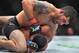 Raphael Assuncao (top) punches Rob Font.