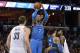 Oklahoma City Thunder forward Carmelo Anthony (7) shoots ahead of Memphis Grizzlies center Marc Gasol (33) as Thunder center Steven Adams (12) and Grizzlies forward Jarell Martin, far right, move for position in the first half of an NBA basketball game Wednesday, Feb. 14, 2018, in Memphis, Tenn. (AP Photo/Brandon Dill)