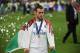 Real Madrid's Welsh forward Gareth Bale with his winner's medal and a Welsh flag on the pitch as Real Madrid players celebrate winning the UEFA Champions League final football match between Liverpool and Real Madrid at the Olympic Stadium in Kiev, Ukraine on May 26, 2018. - Real Madrid defeated Liverpool 3-1. (Photo by Paul ELLIS / AFP) (Photo credit should read PAUL ELLIS/AFP/Getty Images)