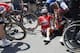 Australia's Richie Porte, right, receives medical attention as he sits on the road with Belgium's Jens Keukeleire, center, after crashing during the ninth stage of the Tour de France cycling race over 156.5 kilometers (97.2 miles) with start in Arras and finish in Roubaix, France, Sunday, July 15, 2018. Porte quit the race after the crash. (AP Photo/Christophe Ena )