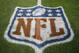 FILE - In this Nov. 12, 2017, file photo, an NFL logo is displayed on the field before an NFL football game between the New England Patriots and the Denver Broncos in Denver. Fox and the NFL have agreed to a five-year deal for Thursday night football games, Fox announced Wednesday, Jan. 31, 2018. Those games previously were televised by CBS and NBC, two of the league's other network partners. (AP Photo/Jack Dempsey, File)