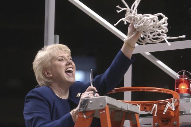 FILE - In this March 2, 2003 file photo Penn State women's basketball coach Rene Portland waves the net she cut down to celebrate their Big 10 regular season championship after defeating Wisconsin in State College, Pa. Portland, who built Penn State into a women's basketball powerhouse during a 27-year tenure, has died after a three-year fight with cancer. She was 65. D'Anjolell Memorial Home of Broomall in Pennsylvania confirmed her death Sunday, July 22, 2018. (AP Photo/Pat Little, file)