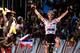 France's Julian Alaphilippe, wearing the best climber's polka dot jersey, celebrates as he crosses the finish line to win the 16th stage of the 105th edition of the Tour de France cycling race, between Carcassonne and Bagneres-de-Luchon, southwestern France, on July 24, 2018. (Photo by Philippe LOPEZ / AFP) / ALTERNATIVE CROP (Photo credit should read PHILIPPE LOPEZ/AFP/Getty Images)