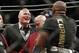 Brock Lesnar, left, taunts Daniel Cormier after Cormier's heavyweight title mixed martial arts bout at against Stipe Miocic at UFC 226, Saturday, July 7, 2018, in Las Vegas. (AP Photo/John Locher)