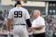 NEW YORK, NY - JULY 26: Aaron Judge #99 of the New York Yankees is looked at after he was hit by a pitch in the first inning against the Kansas City Royals at Yankee Stadium on July 26, 2018 in the Bronx borough of New York City. (Photo by Elsa/Getty Images)