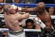 FILE - In this Aug. 26, 2017, file photo, Floyd Mayweather Jr. hits Conor McGregor in a super welterweight boxing match in Las Vegas. The AP reported on Sept. 1, 2017, that a story claiming a boxing promoter connected to the fight was found shot dead in Washington, D.C. is a hoax. (AP Photo/Eric Jamison, File)