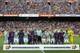 Barcelona and Betis players and the referee mix together for a photo before observing a minute of silence for the victims of the van attacks before a La Liga soccer match between Barcelona and Betis at the Camp Nou stadium in Barcelona, Spain, Sunday, Aug. 20, 2017. Security was stepped up for the match after a terror attack that killed 14 people and wounded over 120 in Barcelona and police put up scores of roadblocks across northeast Spain on Sunday in hopes of capturing a fugitive suspect at large following the vehicle attack. (AP Photo/Manu Fernandez)