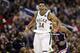 Milwaukee Bucks forward Giannis Antetokounmpo (34), from Greece, celebrates after making a shot over Washington Wizards forward Kelly Oubre Jr. (12) during the second half of an NBA basketball game Saturday, Jan. 6, 2018, in Washington. The Bucks won 110-103. (AP Photo/Alex Brandon)