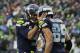 Seattle Seahawks quarterback Russell Wilson (3) gives a pat to Doug Baldwin after Baldwin caught a touchdown pass against the St. Louis Rams in the second half of an NFL football game, Sunday, Dec. 27, 2015, in Seattle. (AP Photo/Stephen Brashear)
