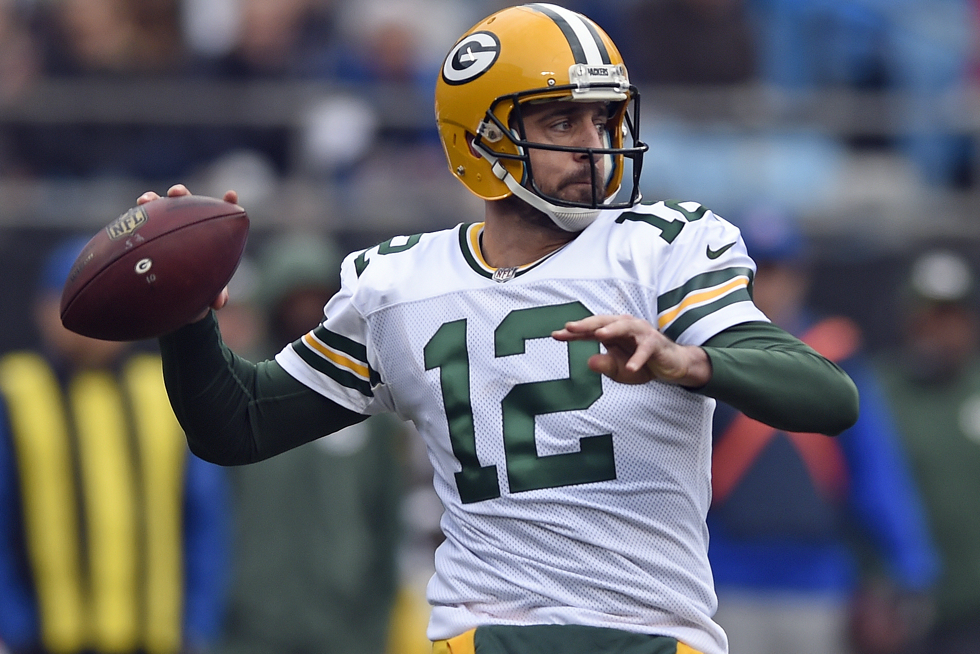 FILE - In this Dec. 17, 2017, file photo, Green Bay Packers' Aaron Rodgers looks to pass against the Carolina Panthers during the first half of an NFL football game in Charlotte, N.C. Rodgers wants to follow Tom Brady's path and still chuck it when he's in his 40s. He also accepts that in today's NFL he might again follow Brett Favre's footsteps and one day don something other than the green and gold. (AP Photo/Mike McCarn, File)