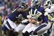 Los Angeles Rams quarterback Sean Mannion (14) is sacked by Baltimore Ravens linebackers Za'Darius Smith, left, and linebacker Matt Judon in the first half of a preseason NFL football game, Thursday, Aug. 9, 2018, in Baltimore. (AP Photo/Nick Wass)