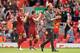 Liverpool's German manager Jurgen Klopp (R) applauds supporters on the pitch after the English Premier League football match between Liverpool and West Ham United at Anfield in Liverpool, north west England on August 12, 2018. (Photo by Oli SCARFF / AFP) / RESTRICTED TO EDITORIAL USE. No use with unauthorized audio, video, data, fixture lists, club/league logos or 'live' services. Online in-match use limited to 120 images. An additional 40 images may be used in extra time. No video emulation. Social media in-match use limited to 120 images. An additional 40 images may be used in extra time. No use in betting publications, games or single club/league/player publications. / (Photo credit should read OLI SCARFF/AFP/Getty Images)
