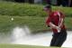 Tiger Woods hits out of the bunker on the sixth green during the final round of the PGA Championship golf tournament at Bellerive Country Club, Sunday, Aug. 12, 2018, in St. Louis. (AP Photo/Jeff Roberson)