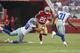 San Francisco 49ers running back Jerick McKinnon (28) runs between Dallas Cowboys defensive end Tyrone Crawford (98) and cornerback Byron Jones (31) during the first half of an NFL preseason football game in Santa Clara, Calif., Thursday, Aug. 9, 2018. (AP Photo/Tony Avelar)
