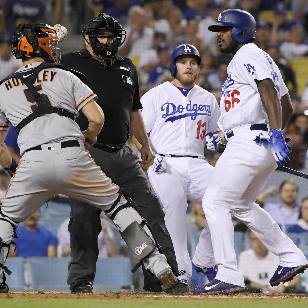 The Dodgers' Yasiel Puig writhes in pain after fouling off…